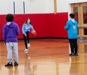 Maple Hill student dribbling basketball.