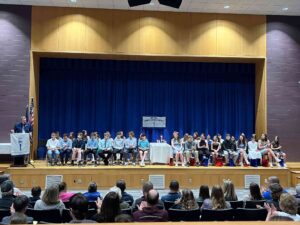 Students on stage at national junior honor society induction