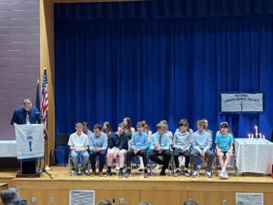Students on stage at national junior honor society induction