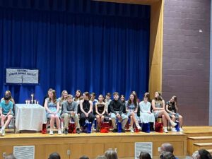 Students on stage at national junior honor society induction