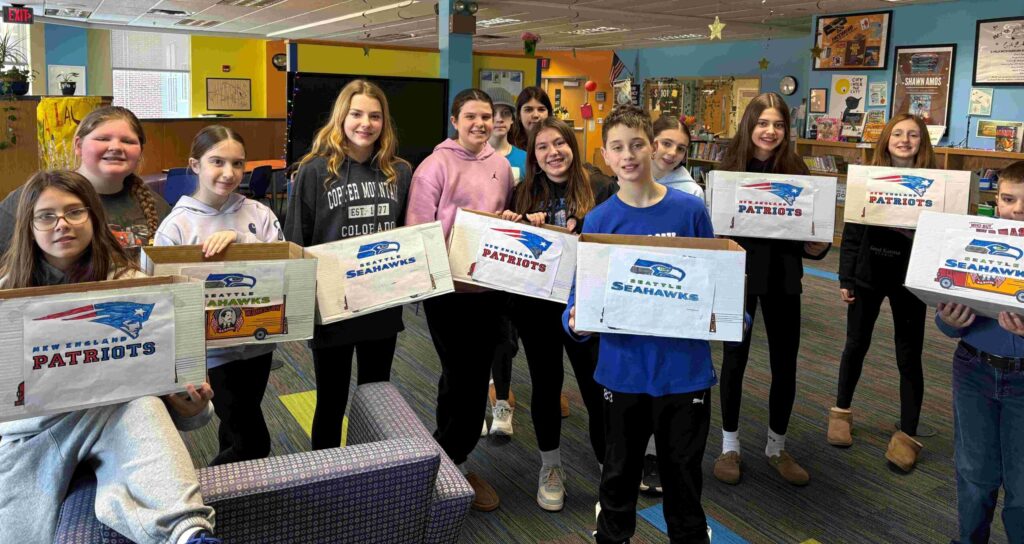 Group of Castleton Elementary students holding donation boxes for Souper Bowl Spirit Week. 